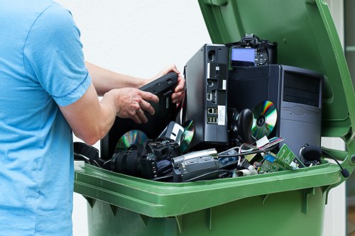 Workers separating waste and loading a van during a commercial clearance